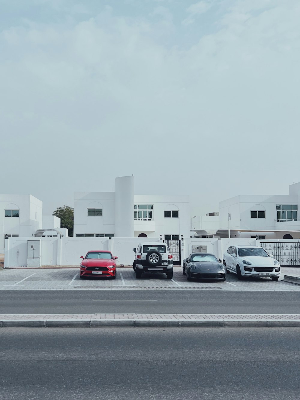 three cars parked in a parking lot next to a building