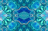 A vibrant kaleidoscope pattern with swirling blues and purples saved on a digital screen.