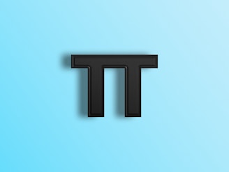 a black letter t on a blue background