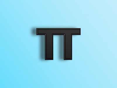 a black letter t on a blue background