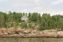 A serene summer house surrounded by nature, representing local recreational spaces managed by the association.