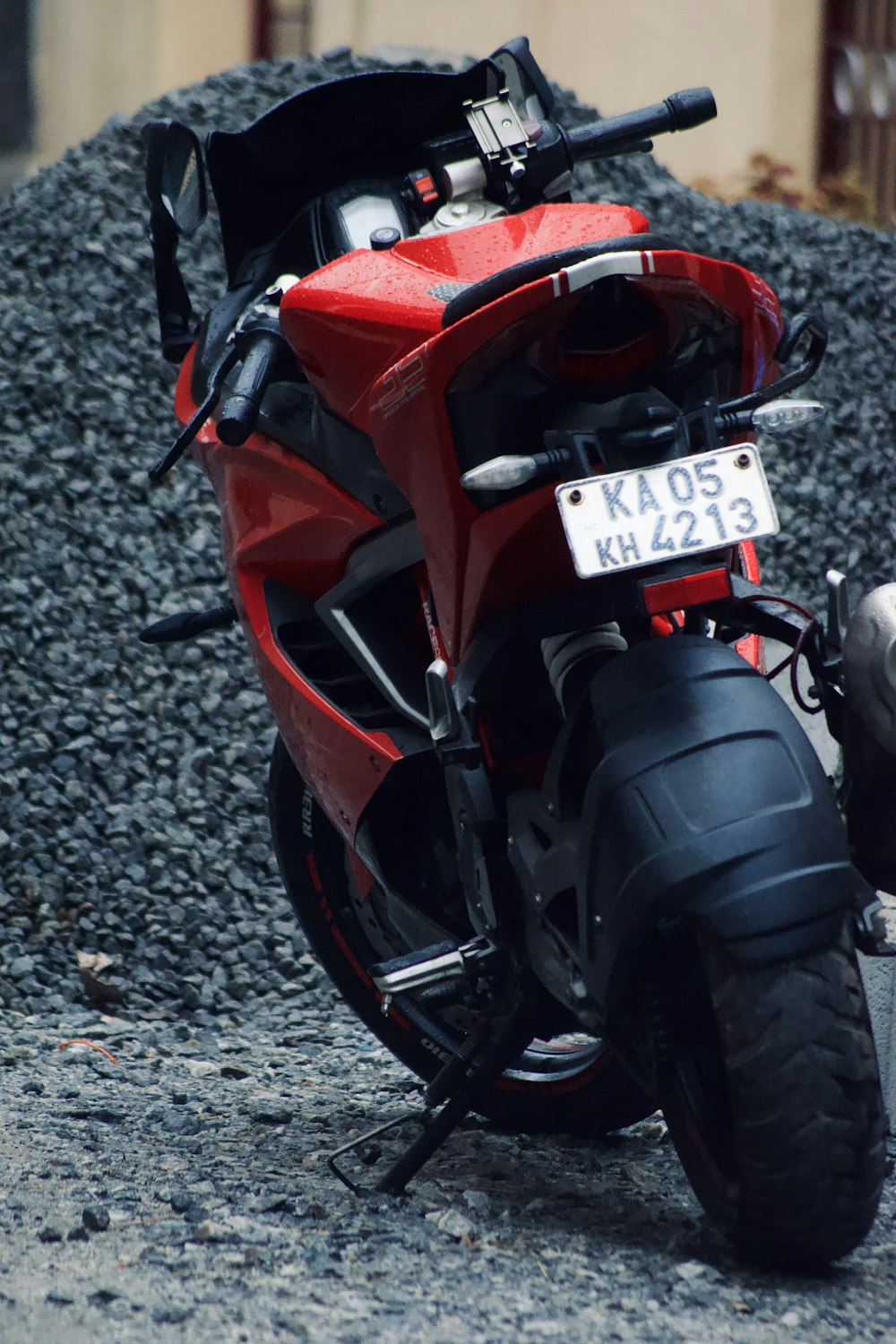 a red motorcycle parked on the side of a road