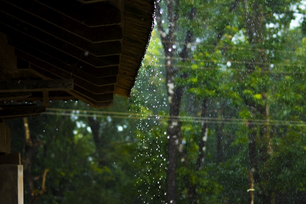 the rain is falling down from the roof of the house