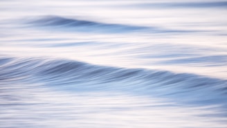 Gentle waves of blue and green light flow like a soothing lullaby, wrapping the viewer in warmth.