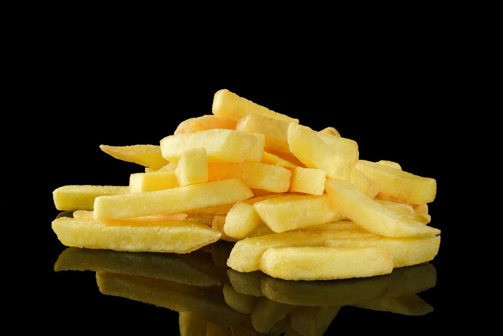 a pile of french fries sitting on top of a table