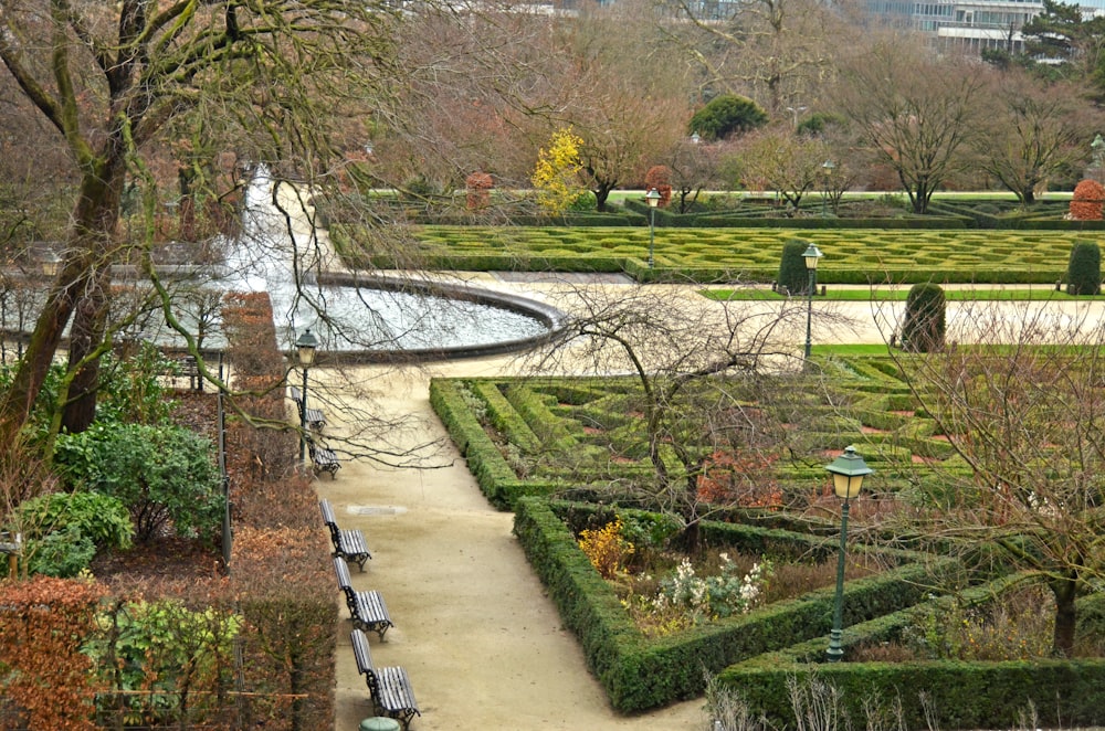 a formal garden with a fountain in the middle