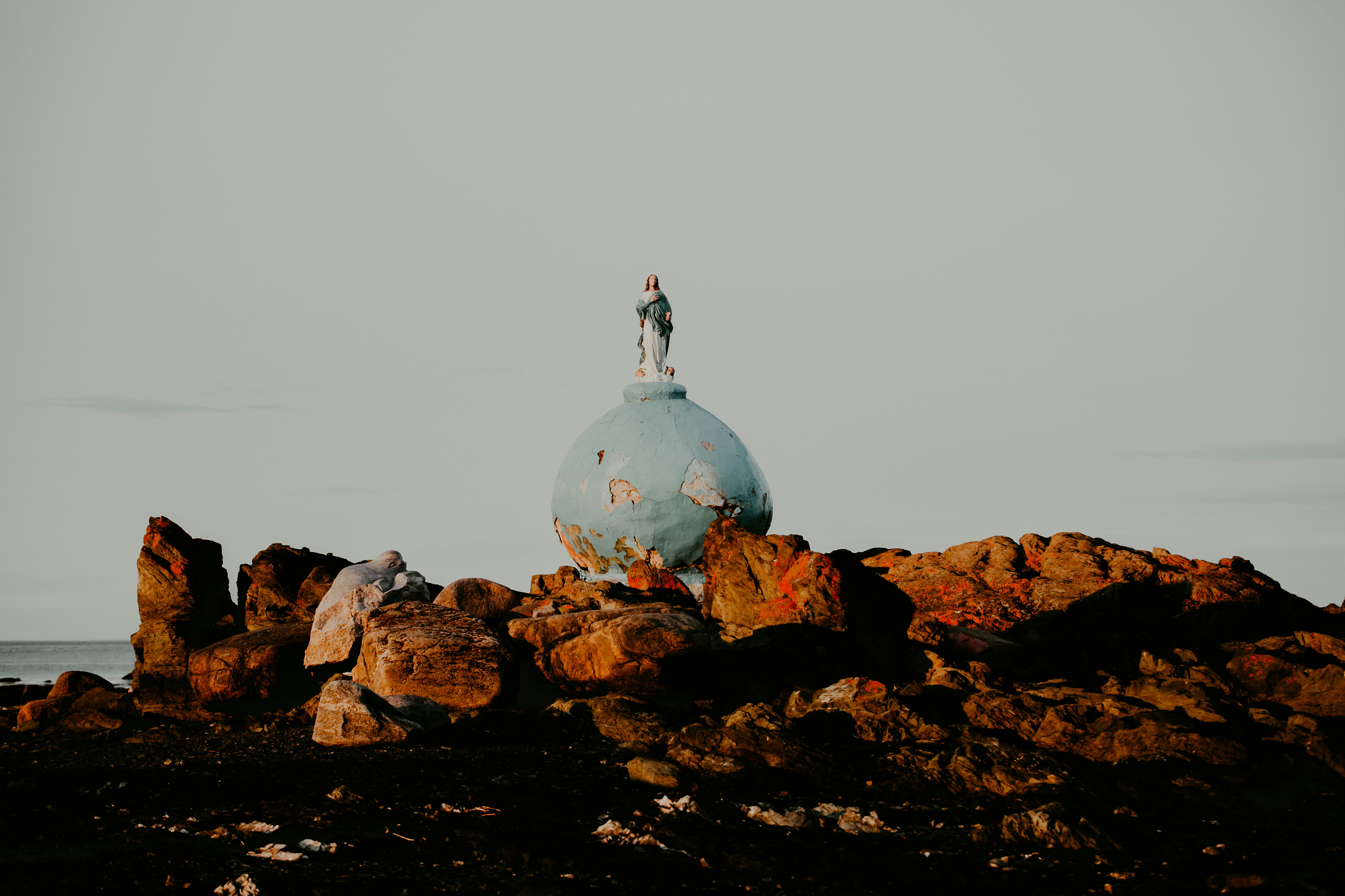 a person standing on top of a rock formation