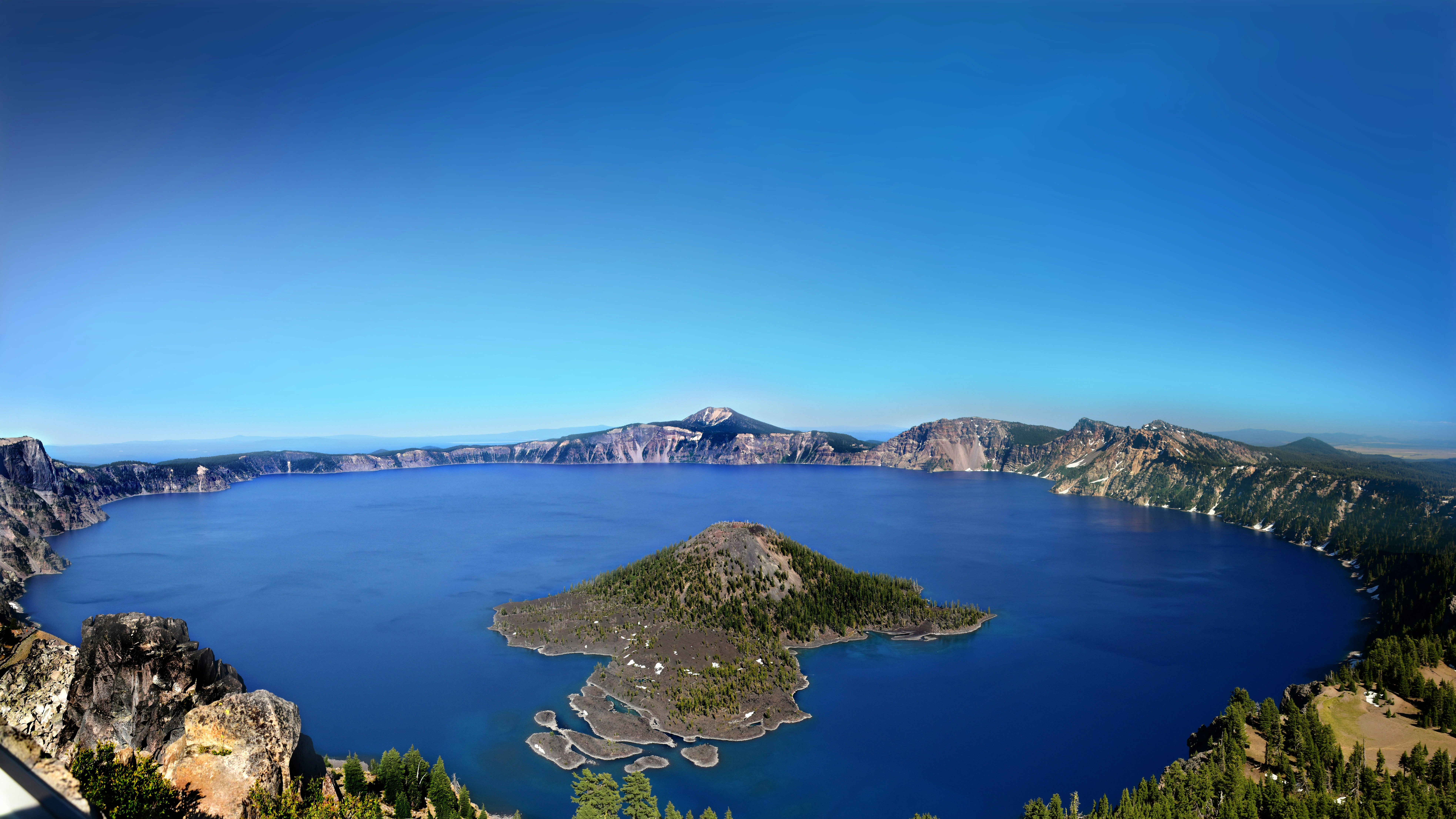 a large body of water surrounded by mountains, A sweeping view from the lookout tower at the top of Watchman Lookout Trail at Crater Lake NP, Oregon, USA.