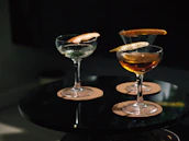 Guests enjoying cocktails on a cozy terrace with black background ambiance.