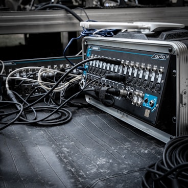 a bunch of wires are plugged into a machine