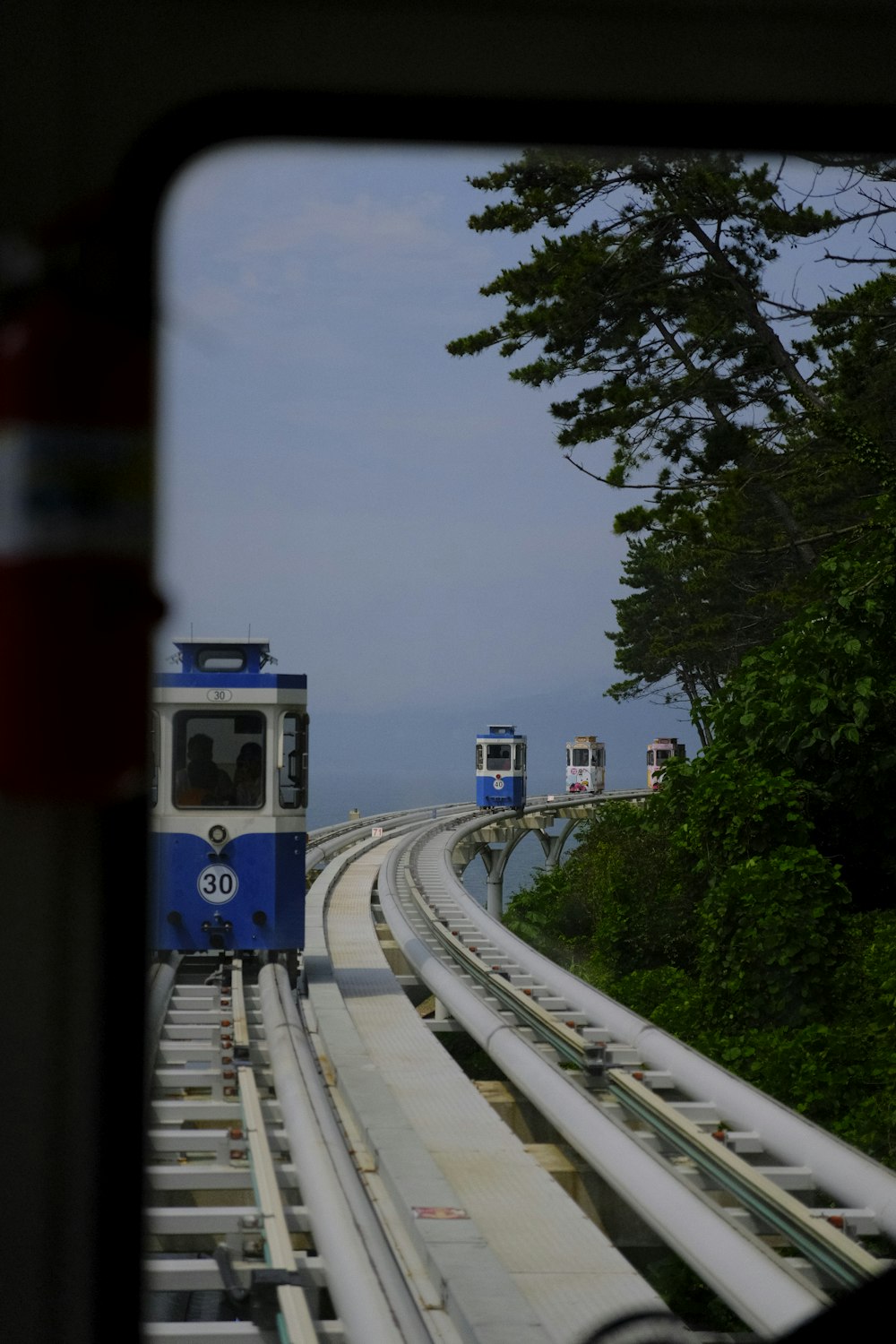 a blue and white train traveling down train tracks