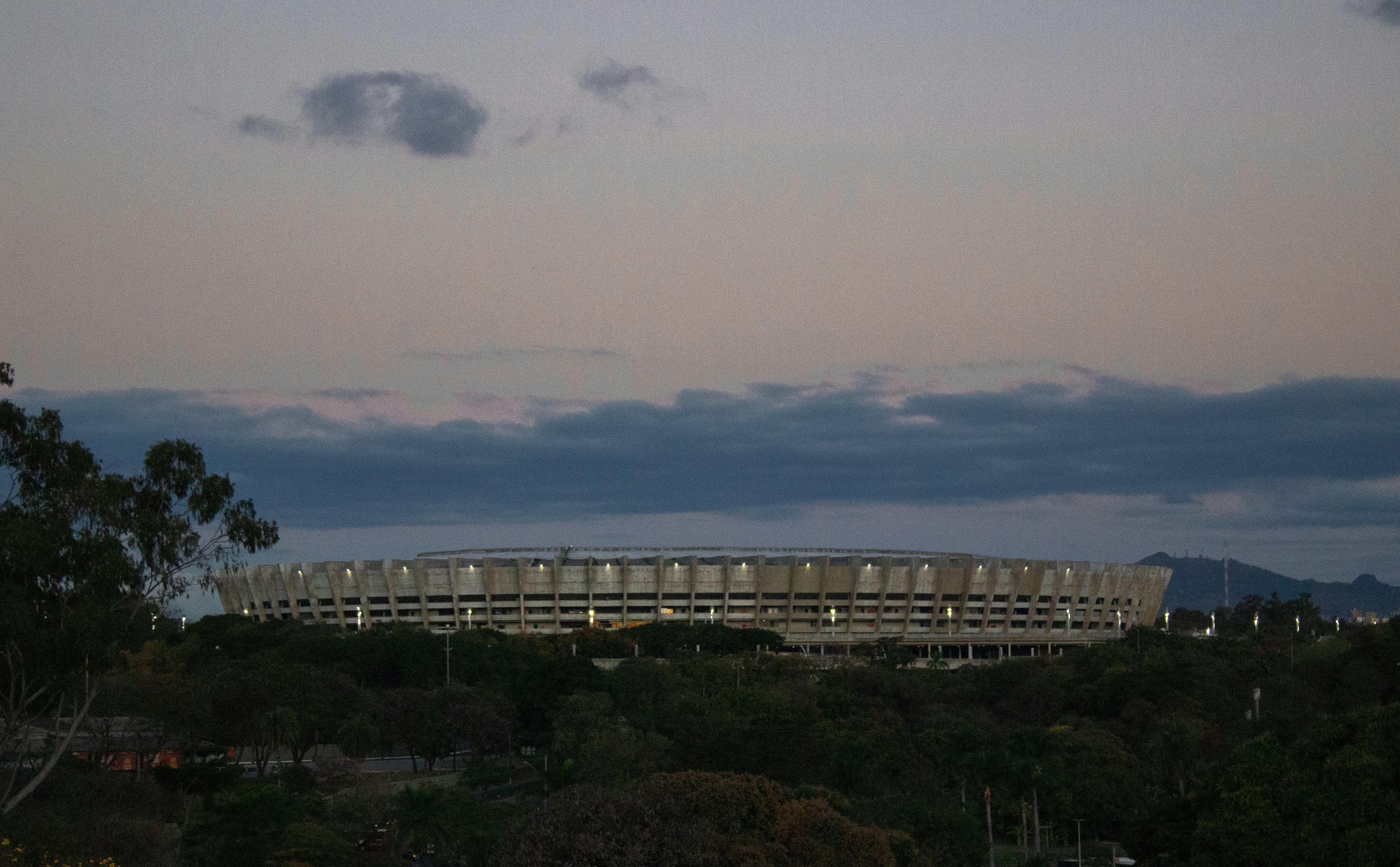 Berlin Olympiastadion panoramic view at dusk, atmospheric golden light, dramatic architecture, deep shadows