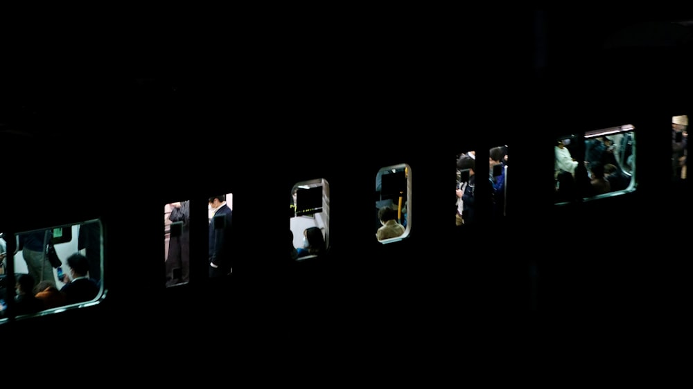 a group of people standing in a window at night