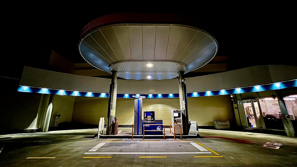 a gas station at night with blue lights