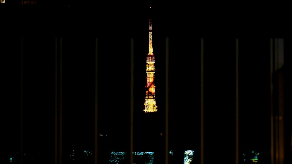 a view of the eiffel tower from behind bars