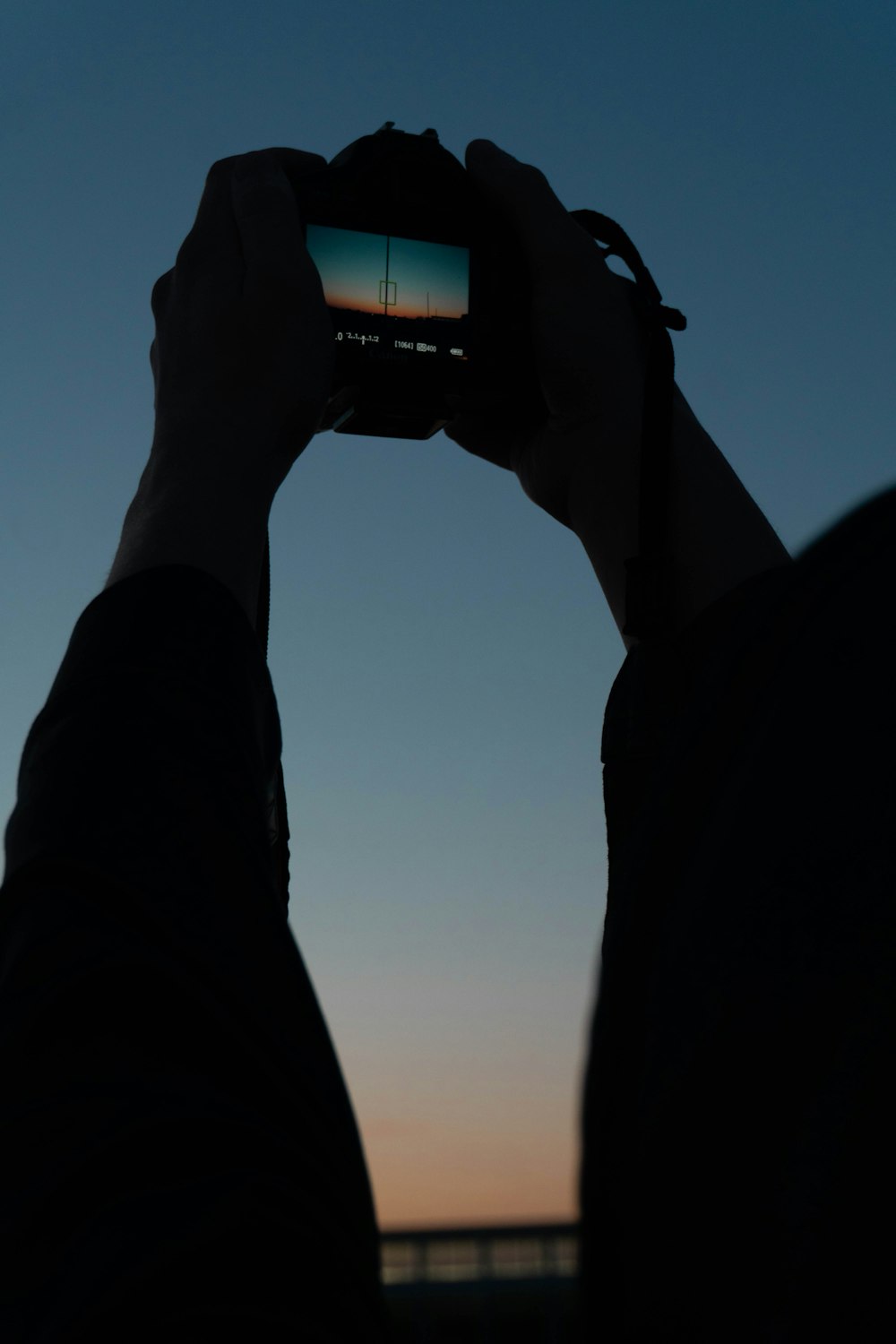 a person holding a camera up to take a picture