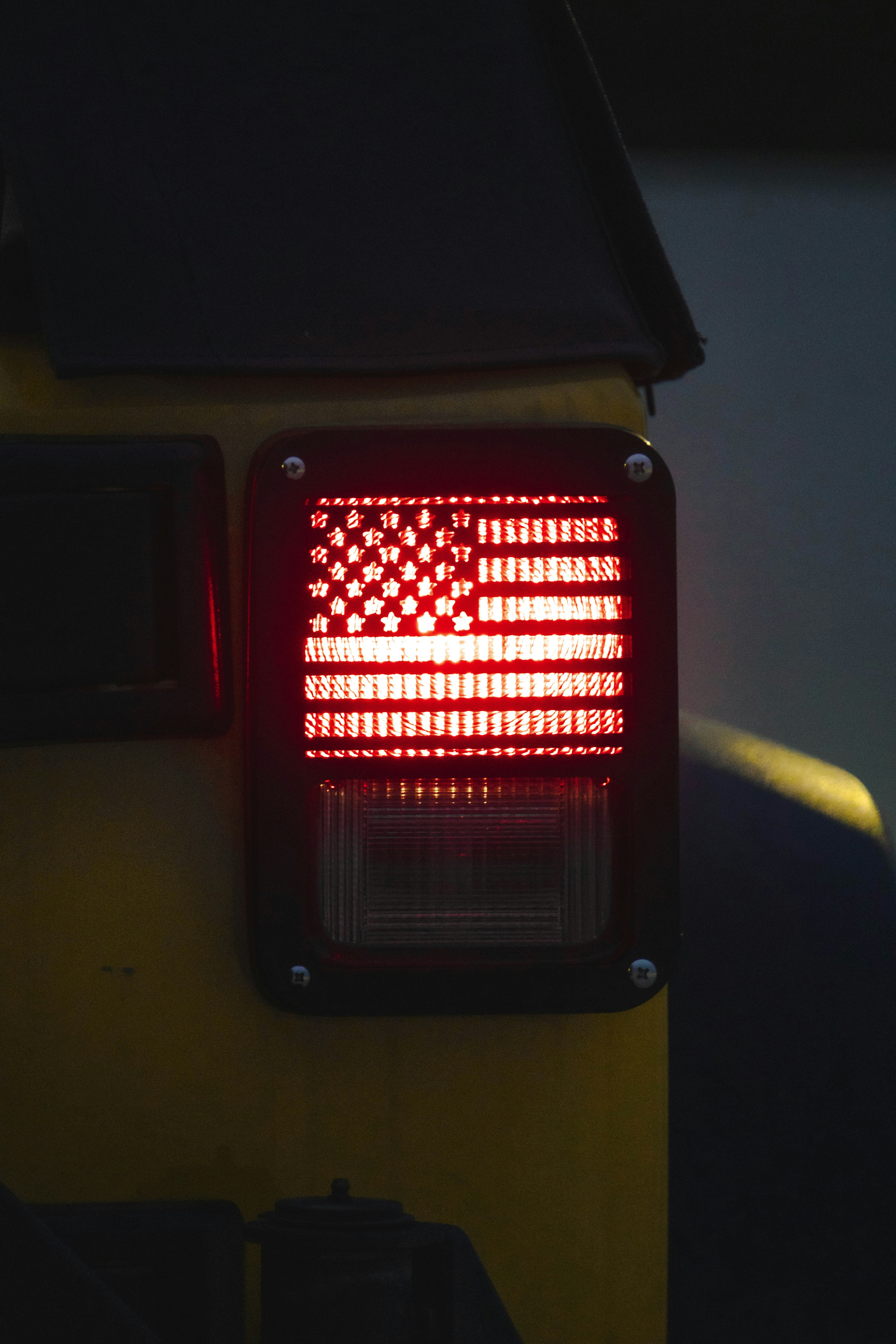 a red stop light with an american flag on it