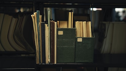 a bookshelf filled with lots of books and papers