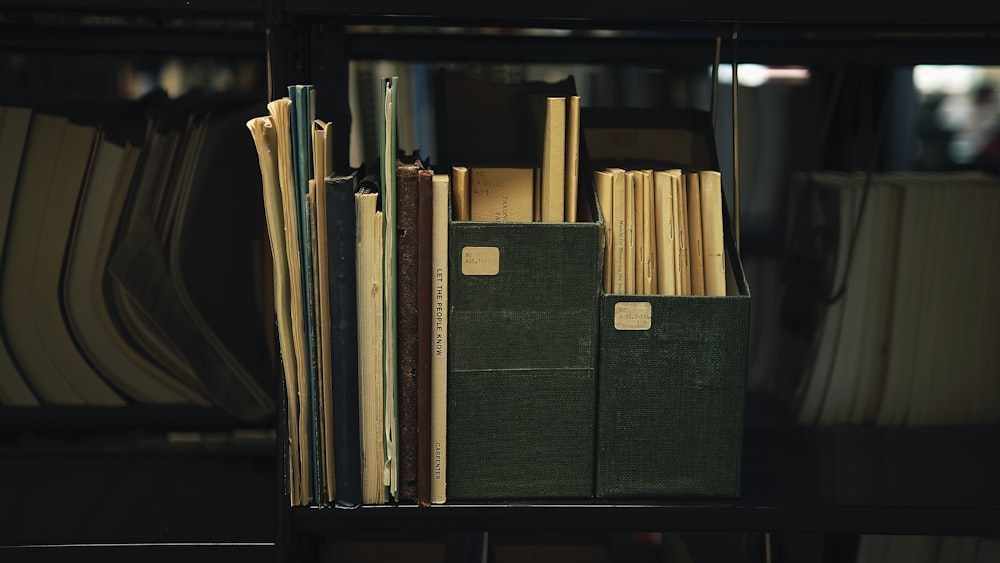 a bookshelf filled with lots of books and papers