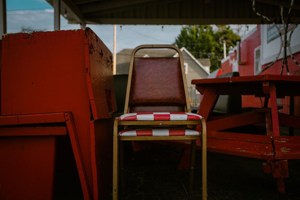 a red and white chair sitting next to a red and white table