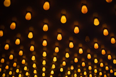 Soft glowing false ceiling lights casting a warm ambiance over a neatly arranged ethnic-patterned bedspread.