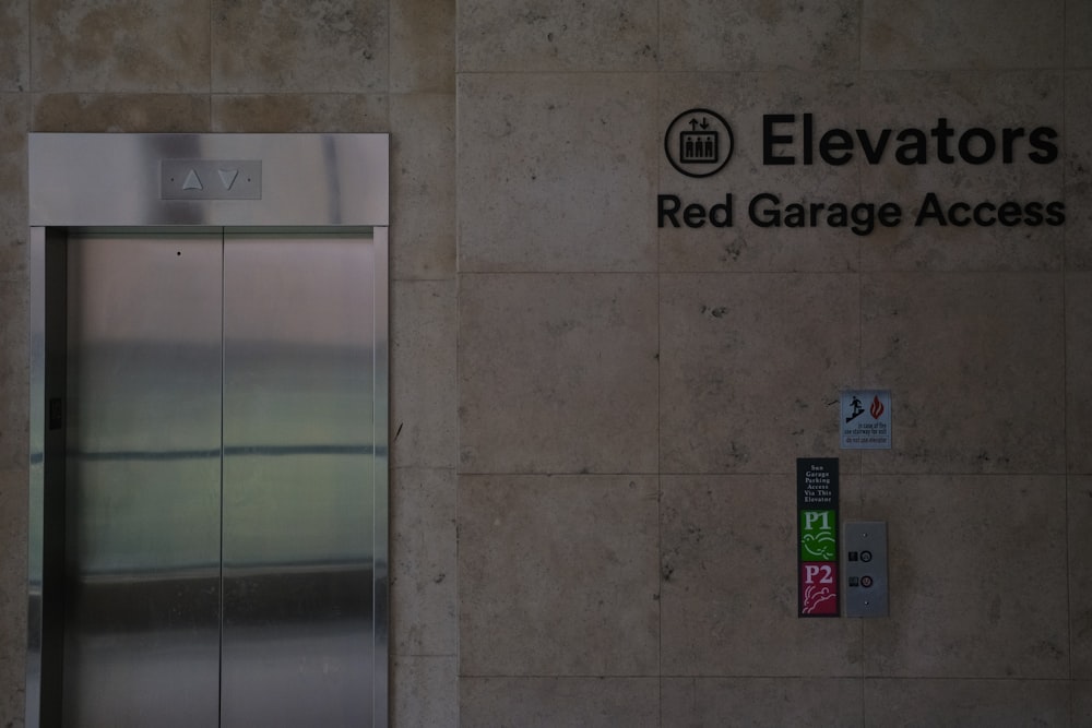 the elevator is next to the red garage access sign