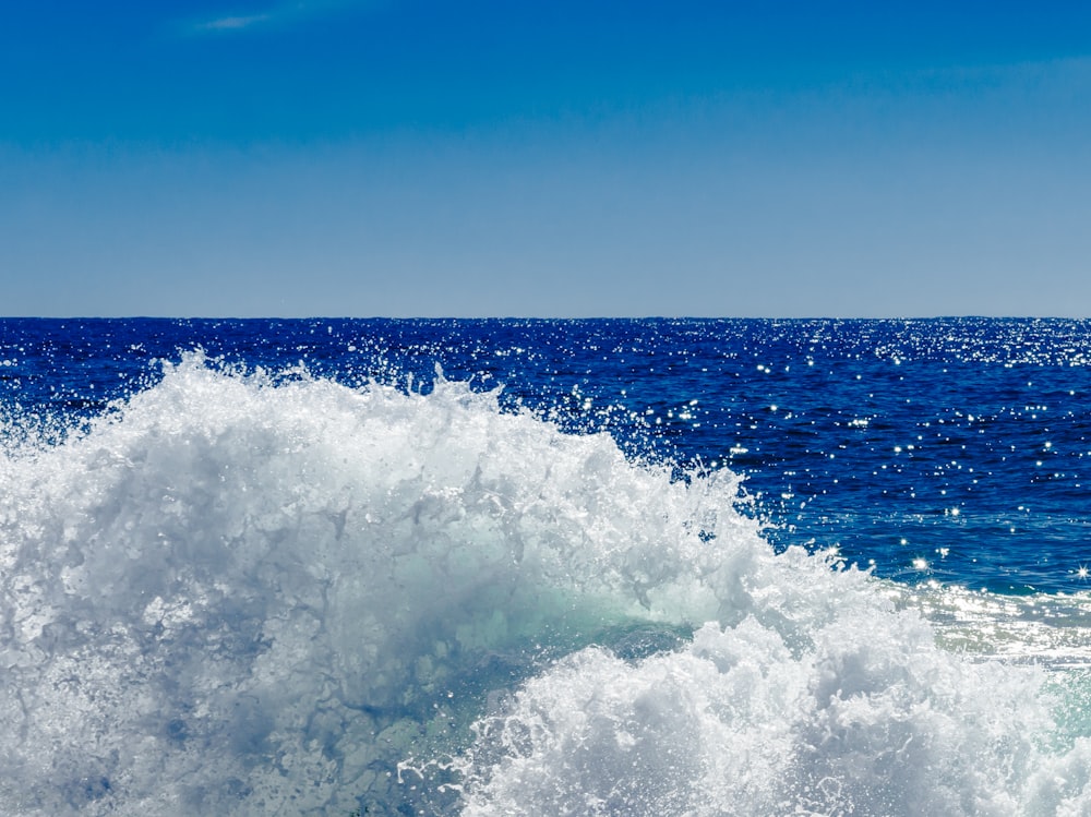 a person riding a surfboard on a wave in the ocean