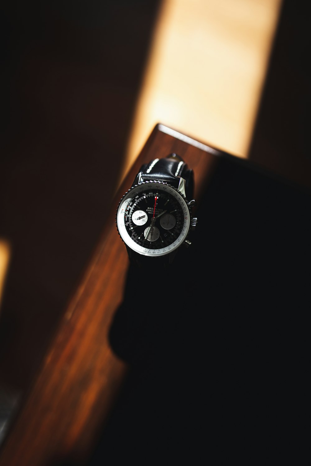 a watch sitting on top of a wooden table