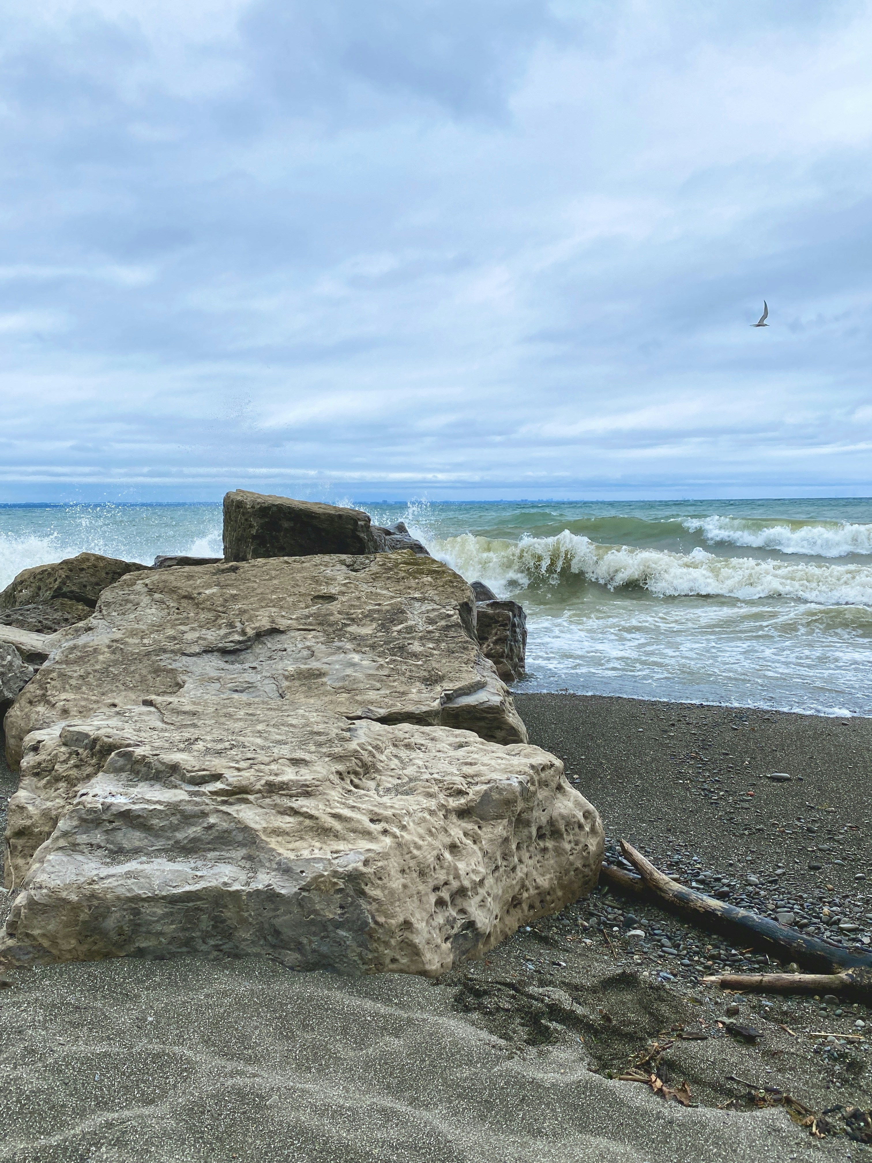 A large rock sitting on top of a sandy beach photo – Free Beach Image ...
