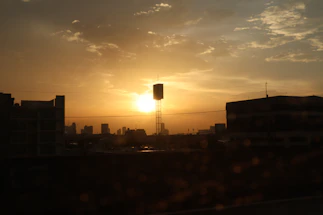 A semi-transparent view of Milwaukee's skyline at dusk with Monnie's Kitchen logo subtly placed in the corner.
