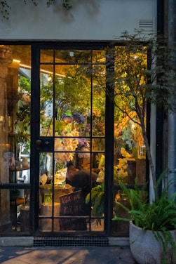 Cozy flower shop interior with vibrant plants and pet supplies neatly arranged.