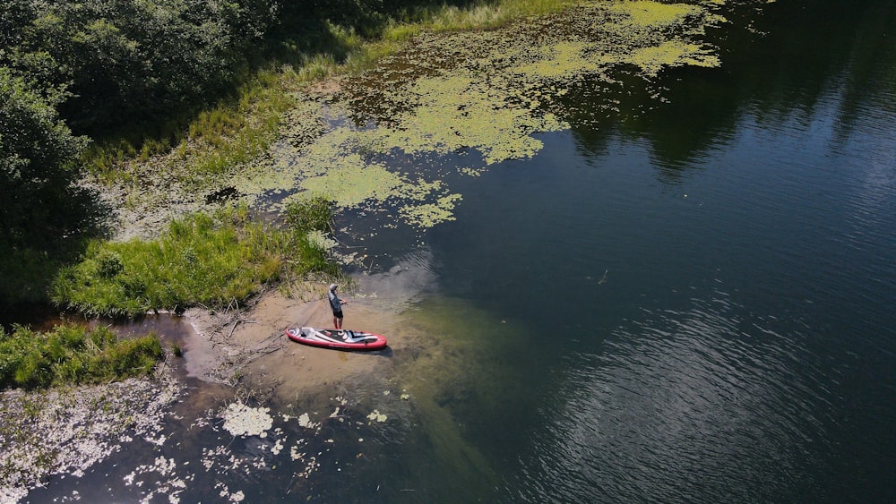 a man standing on a paddle board in the water