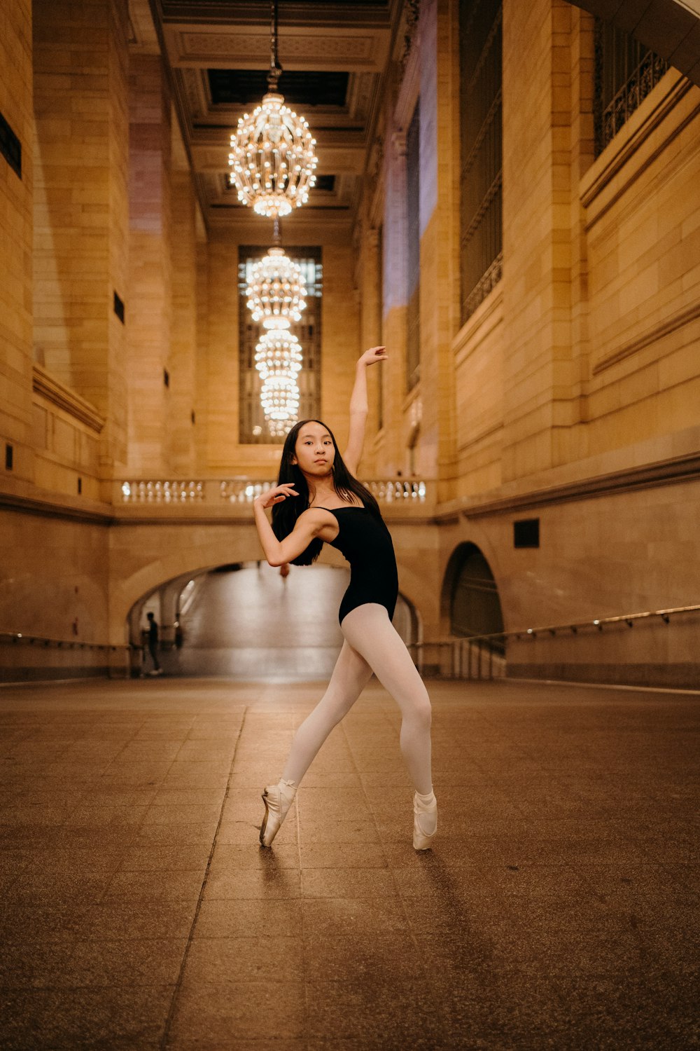 a woman in a black leotard is dancing