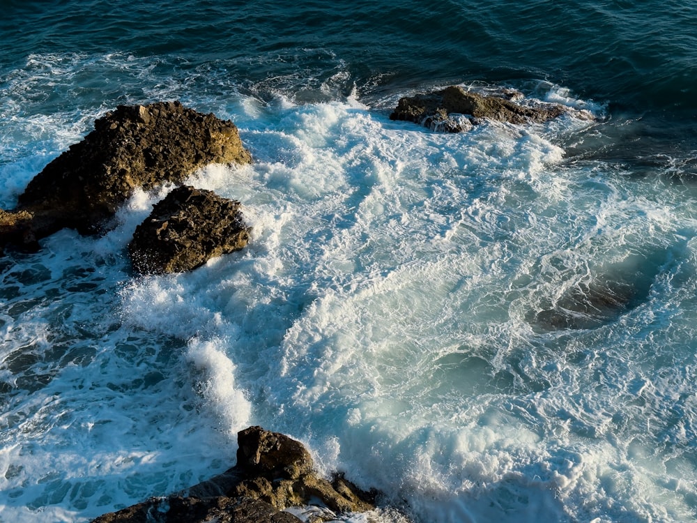 a rocky shore with waves crashing against the rocks