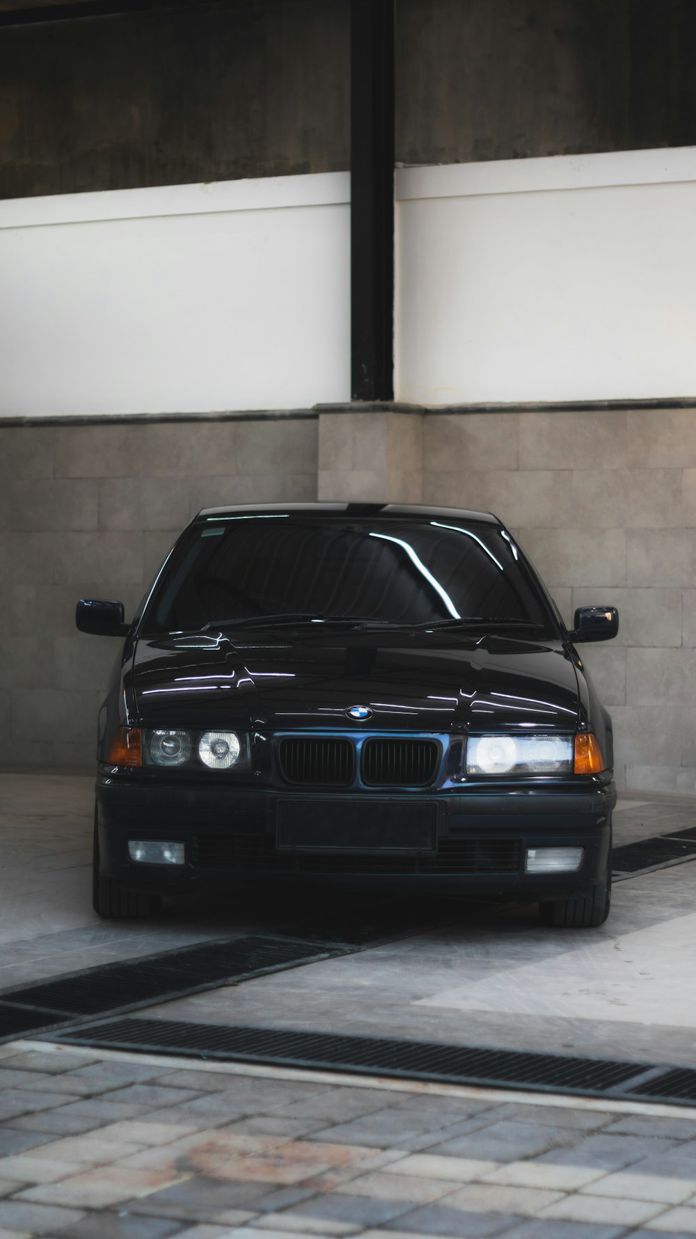 a black car parked in a parking garage