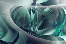 Abstract design featuring swirling patterns and smooth curves in a glass-like appearance. The composition includes a blend of translucent and opaque elements, creating an intricate and dynamic visual effect.