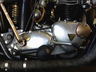 Close-up of motorcycle engine parts arranged on a workbench.