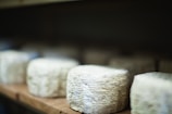 a bunch of cheese sitting on top of a wooden table