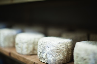 a bunch of cheese sitting on top of a wooden table