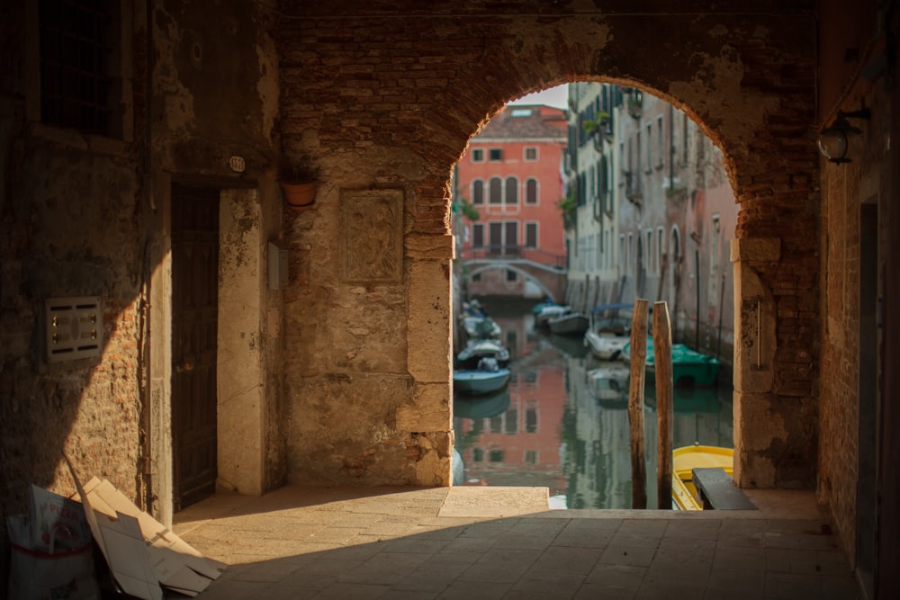 a view of a canal through an arch in a building