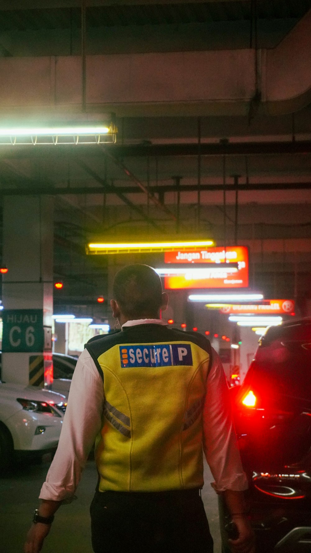 a security officer is standing next to a car