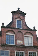 A historic brick apartment building in Ohio, freshly renovated with gold accent details.