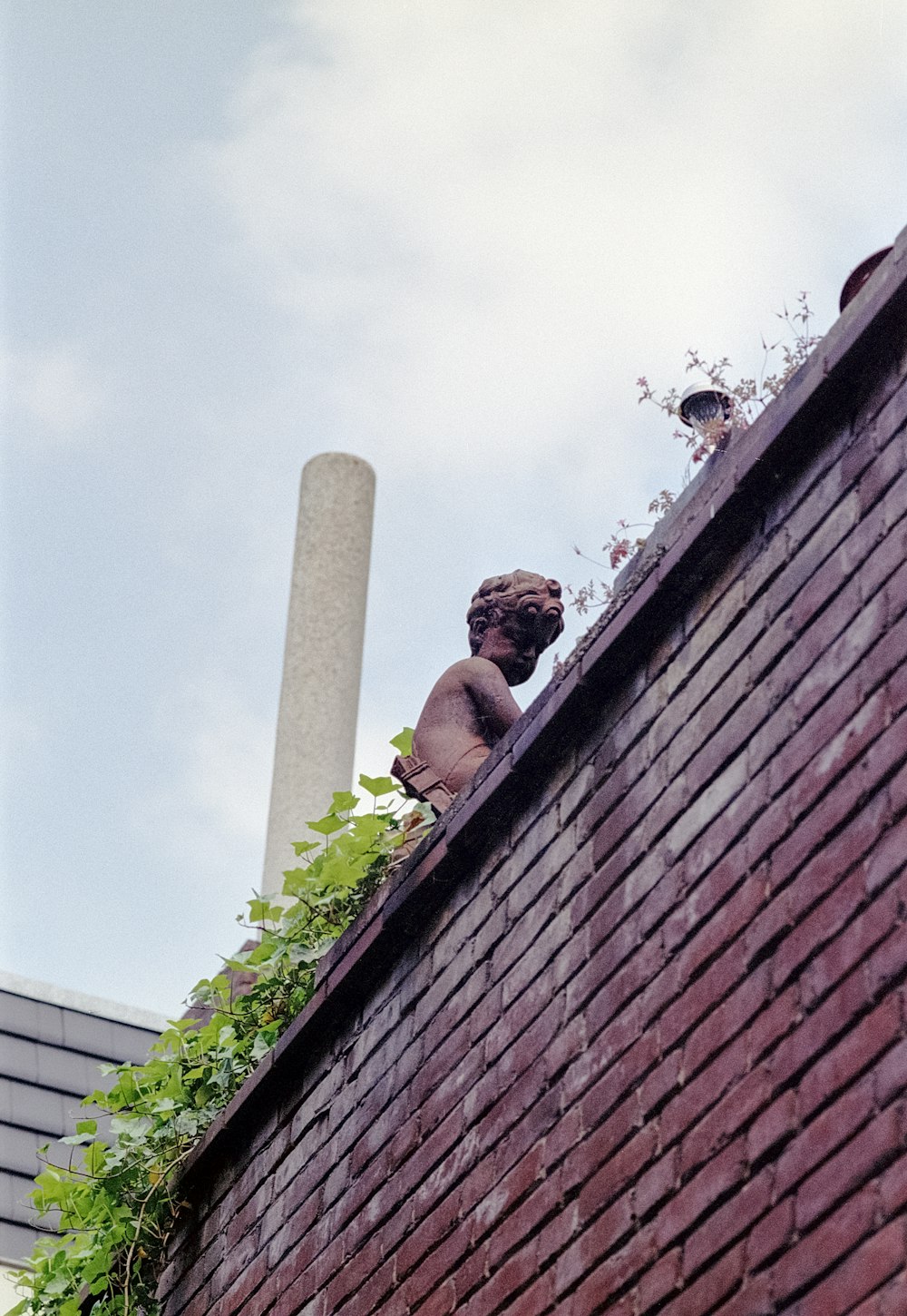 a brick building with a statue on top of it