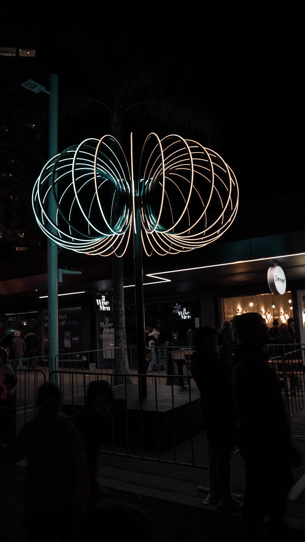 a group of people standing in front of a building at night