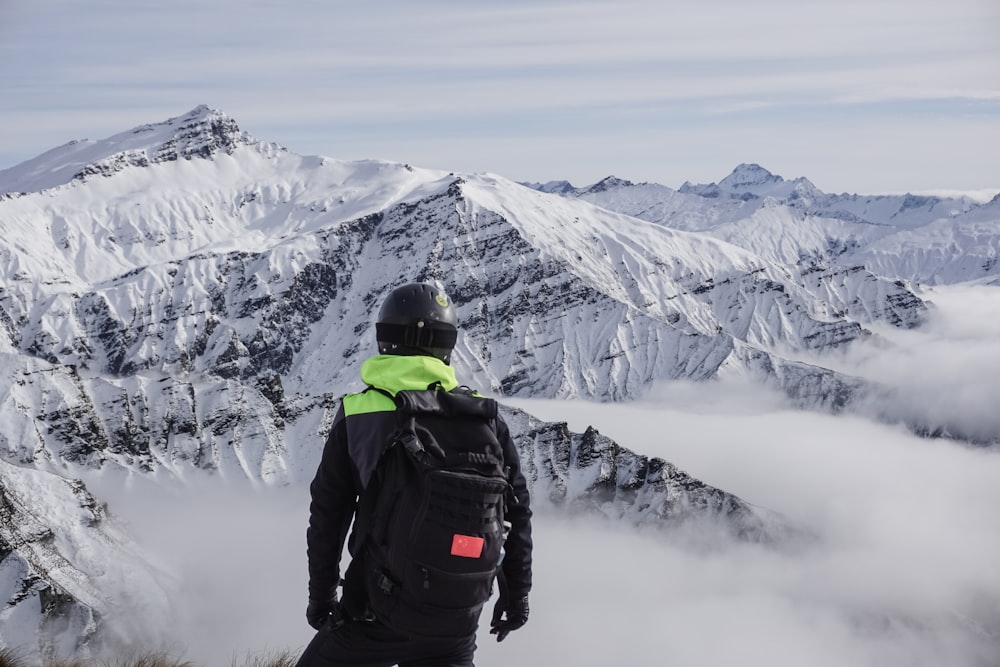 a man standing on top of a snow covered mountain