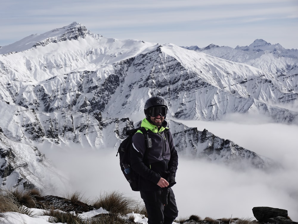 a man standing on top of a snow covered mountain