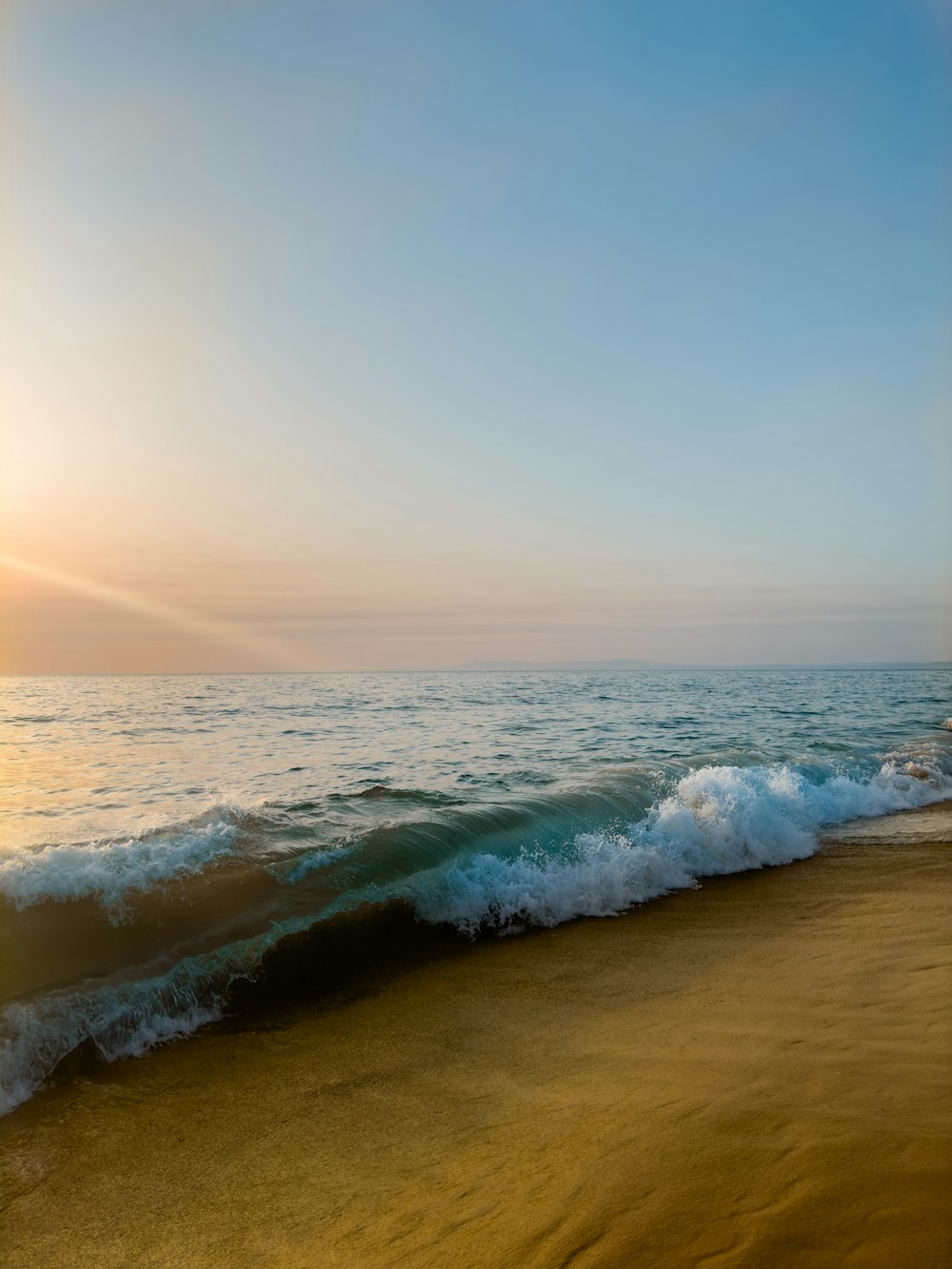 a beach with waves coming in to shore