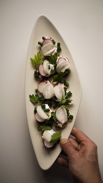 a person is holding a plate of food