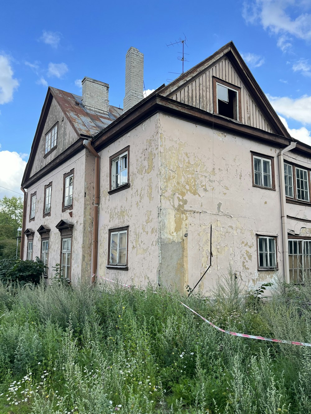 an old run down house in the middle of a field