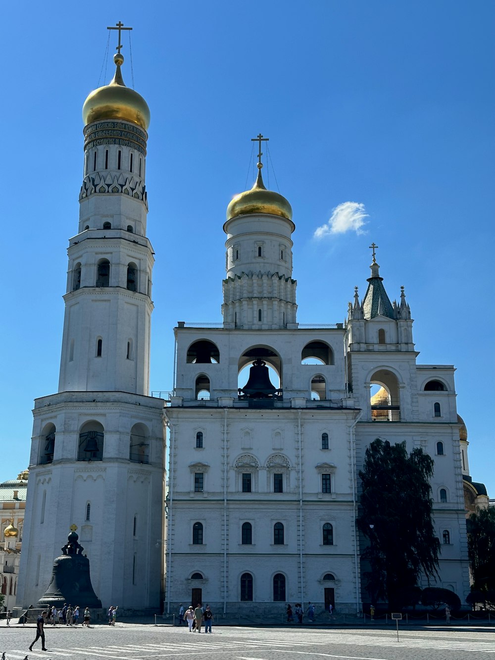 a large white building with two golden domes